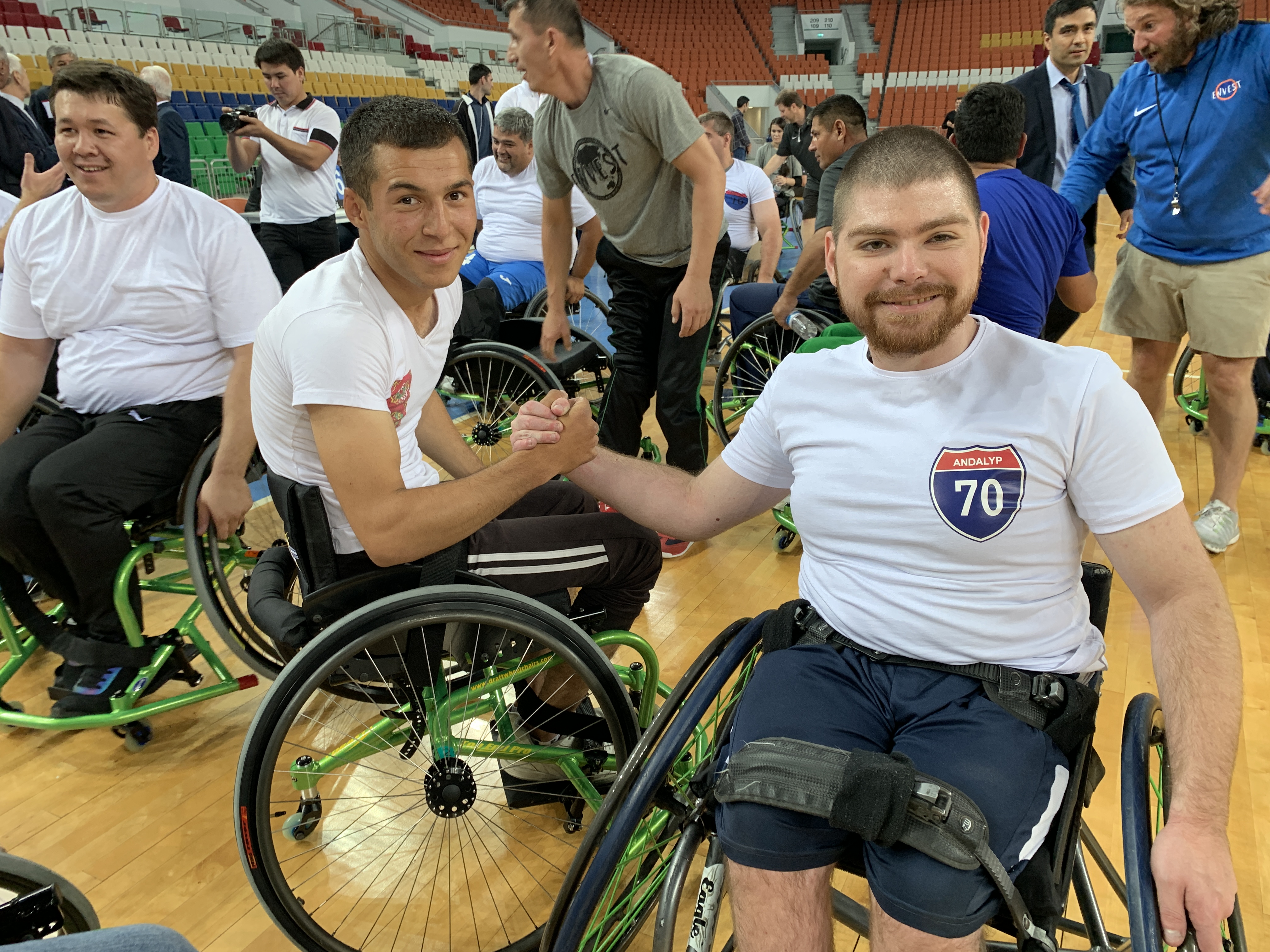 Turkmen wheelchair athletes clasping hands